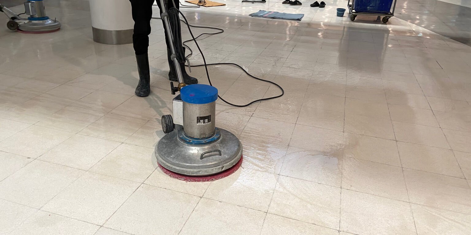 Staff use scrubber to clean the floors in the mall or hotel Staff use scrubber to clean the floors in the mall or hotel