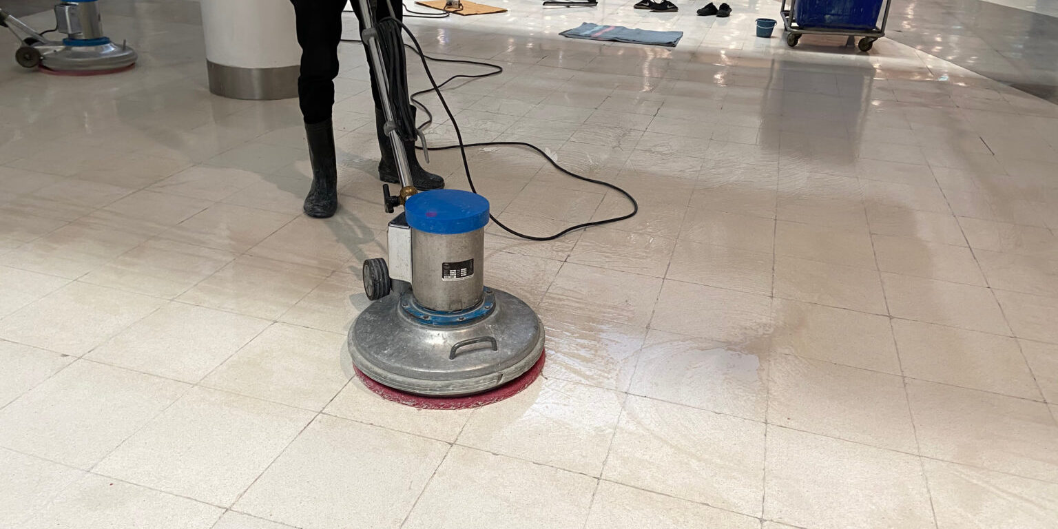 Staff use scrubber to clean the floors in the mall or hotel